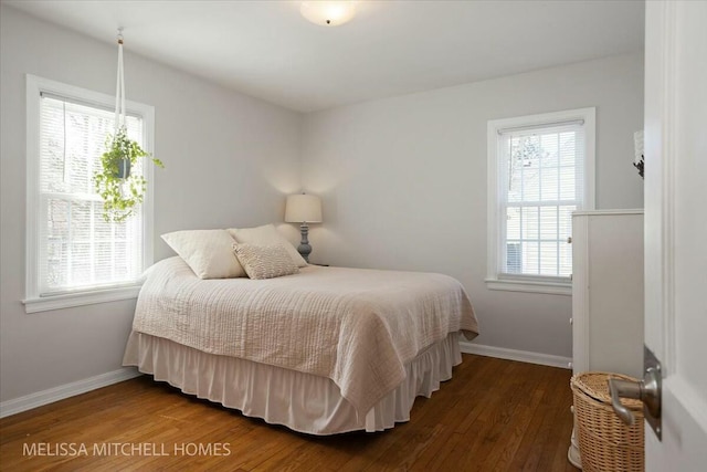 bedroom featuring baseboards and wood-type flooring