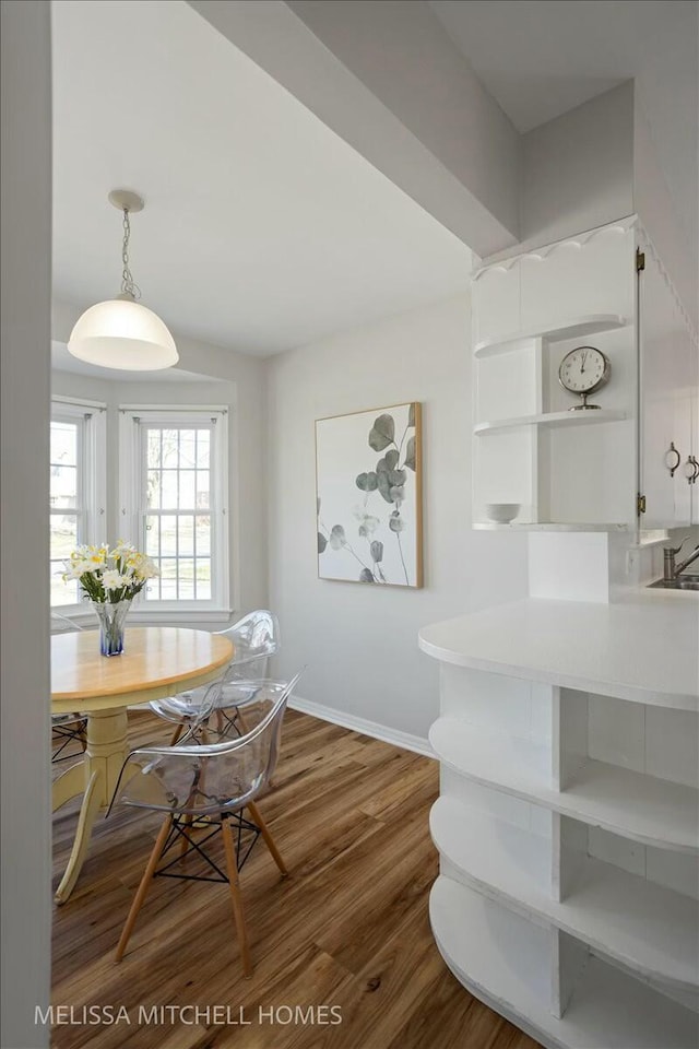 dining area featuring baseboards and wood finished floors