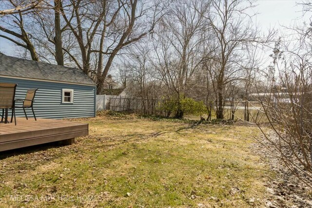 view of yard with a wooden deck and fence