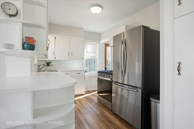 kitchen with open shelves, a sink, stainless steel appliances, white cabinets, and light countertops