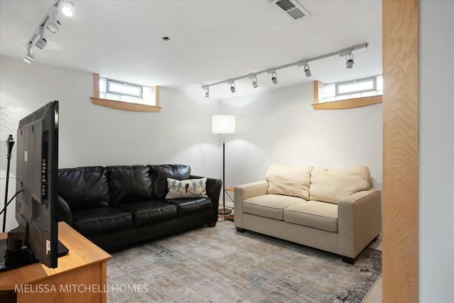 living room featuring visible vents and rail lighting