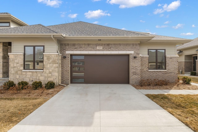 prairie-style home featuring a garage, brick siding, concrete driveway, and a shingled roof