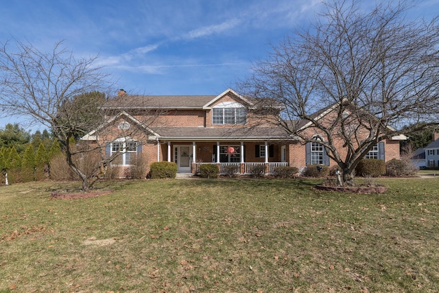 traditional home with a porch, brick siding, a front lawn, and a chimney