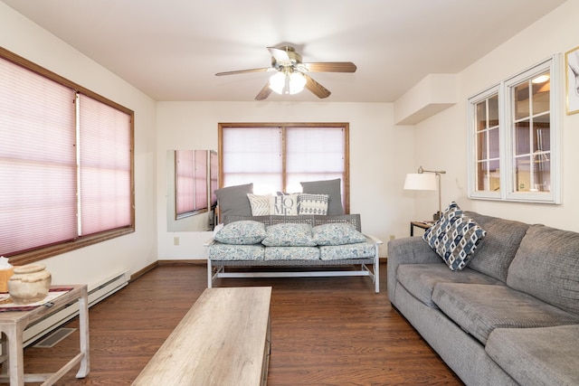 living room with a baseboard radiator, baseboards, dark wood-type flooring, and a ceiling fan