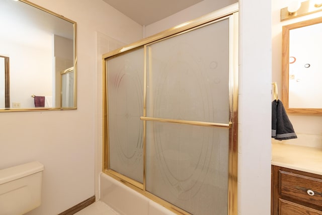 bathroom with vanity, toilet, and enclosed tub / shower combo