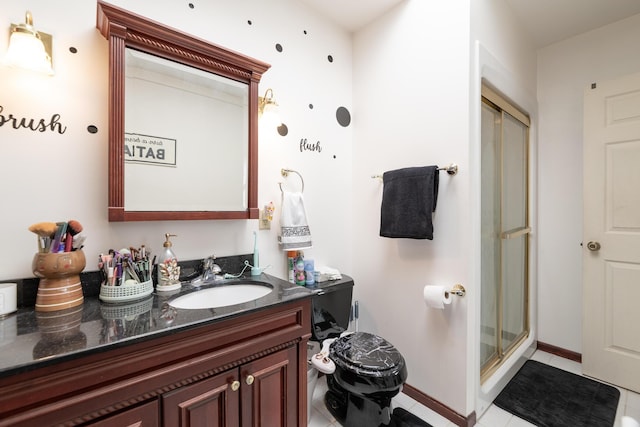 full bath with tile patterned flooring, a stall shower, vanity, and baseboards