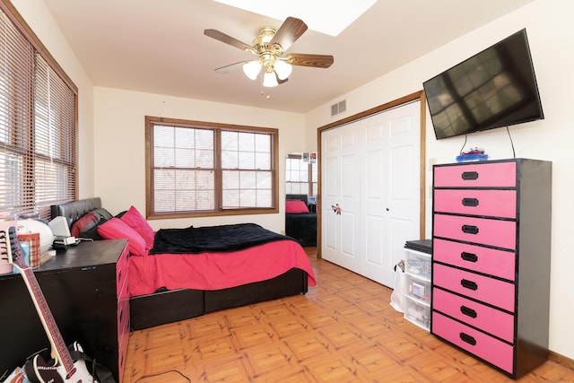 bedroom with visible vents, a closet, and ceiling fan