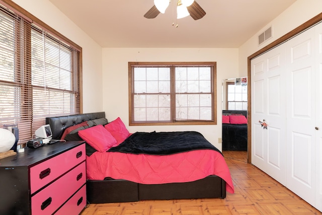 bedroom with visible vents, a closet, and ceiling fan