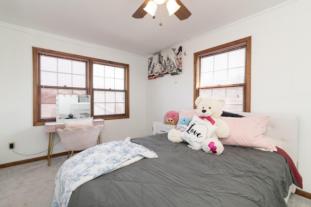 carpeted bedroom with baseboards, multiple windows, and ceiling fan