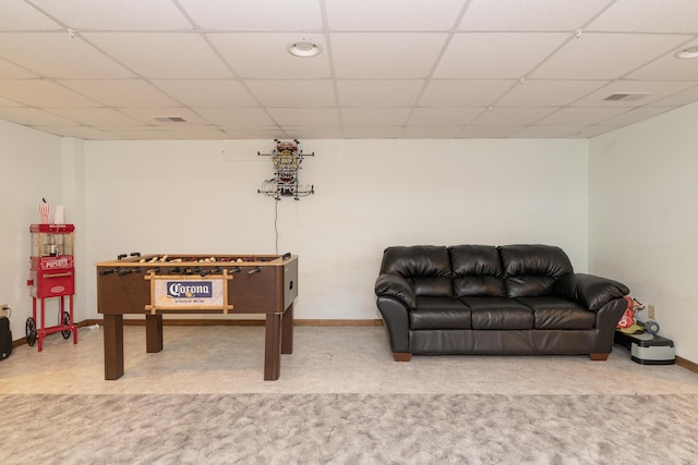 playroom with a drop ceiling and baseboards