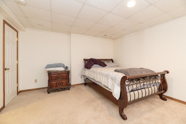 bedroom with a drop ceiling, carpet floors, and baseboards