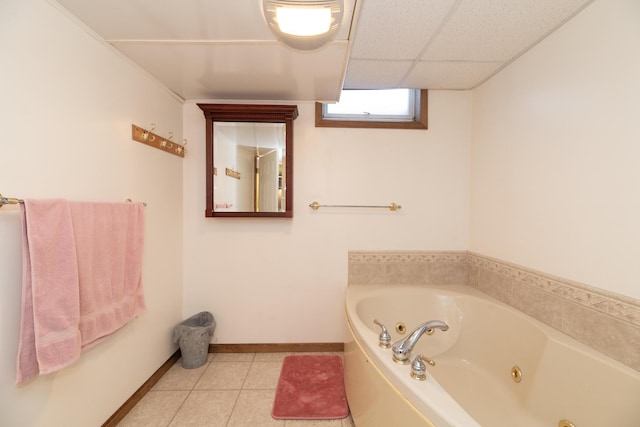 full bathroom featuring tile patterned flooring, a jetted tub, a paneled ceiling, and baseboards