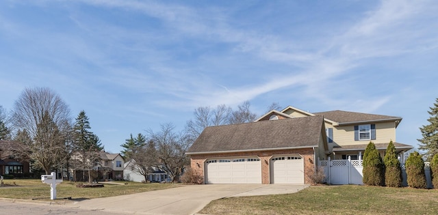 view of side of property featuring fence, an attached garage, concrete driveway, a lawn, and brick siding