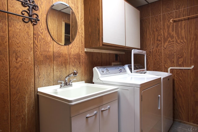 laundry area featuring washing machine and clothes dryer and cabinet space