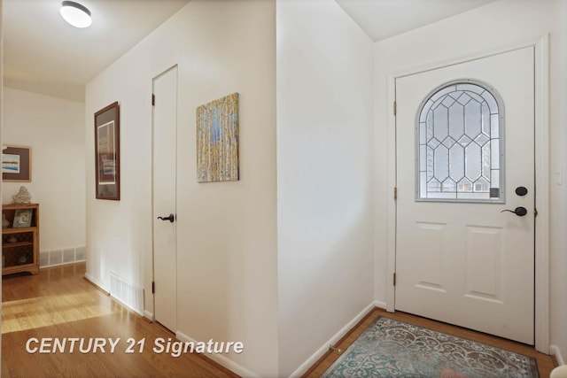 entrance foyer with visible vents, baseboards, and wood finished floors