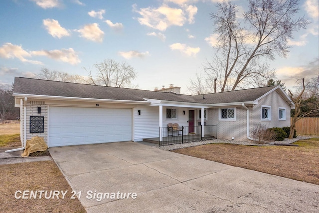 ranch-style home with a porch, roof with shingles, a chimney, driveway, and an attached garage