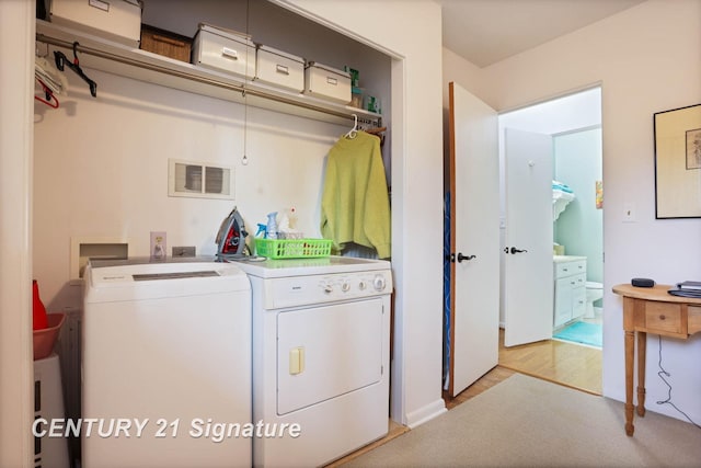 washroom with laundry area, visible vents, and washer and clothes dryer