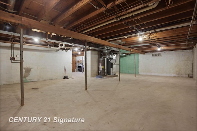 unfinished basement with water heater and heating unit