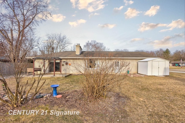 rear view of house with a storage unit, a patio, a yard, an outdoor structure, and brick siding