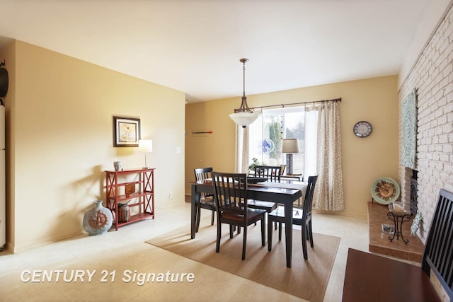 dining space featuring a brick fireplace