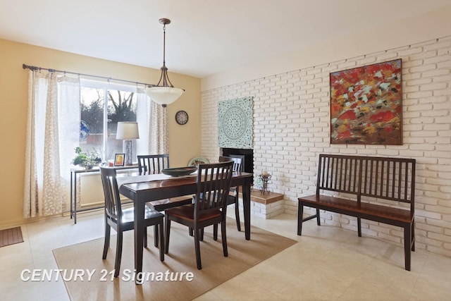 dining room with light tile patterned flooring and a fireplace