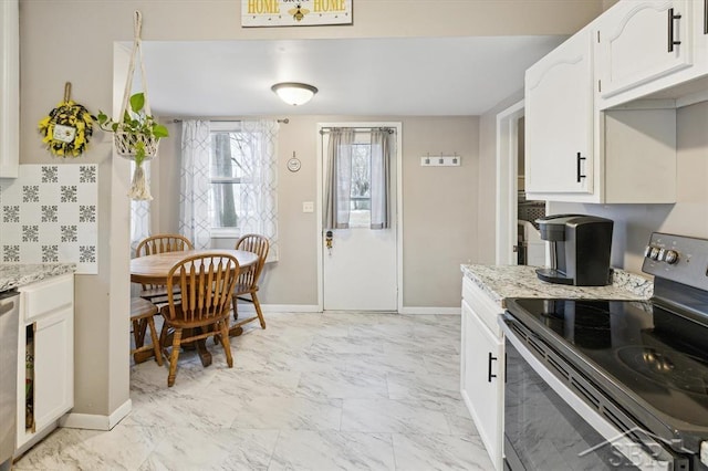 kitchen featuring white cabinetry, light stone countertops, marble finish floor, and stainless steel appliances