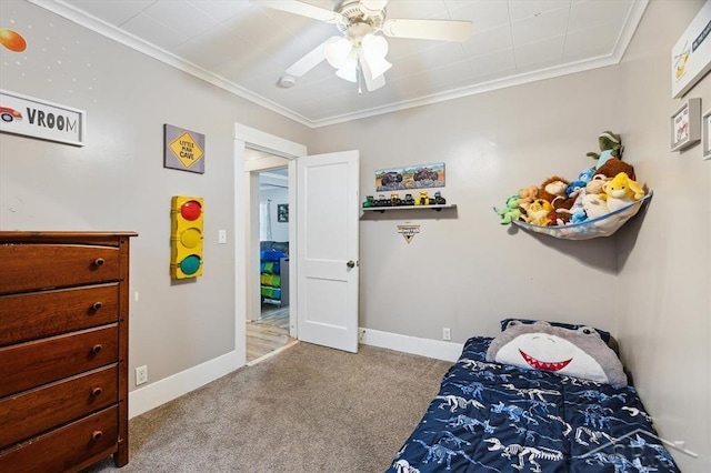 bedroom with baseboards, carpet floors, ornamental molding, and a ceiling fan