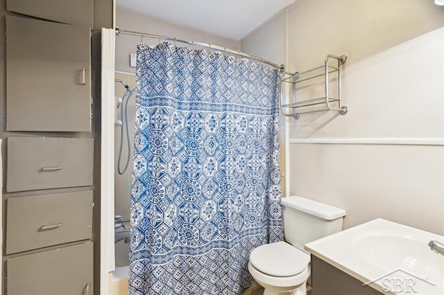 full bathroom featuring a sink, shower / bathtub combination with curtain, and toilet