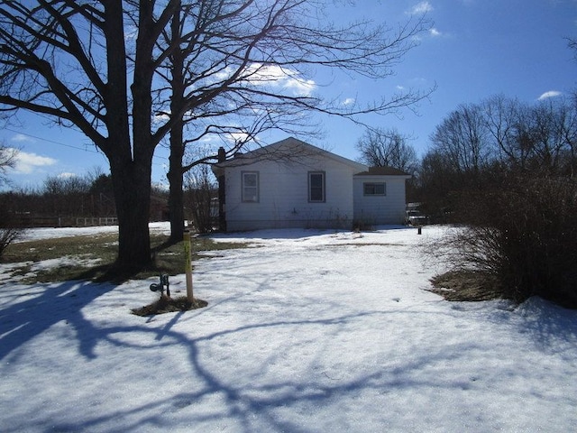 snow covered house with a chimney