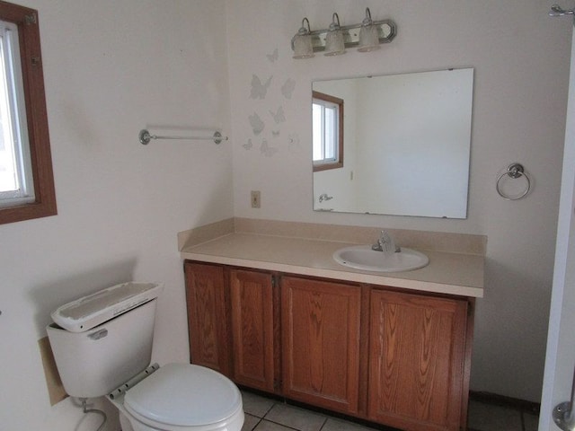 bathroom with tile patterned floors, toilet, and vanity