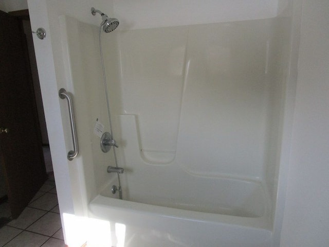 bathroom featuring tile patterned flooring and bathing tub / shower combination