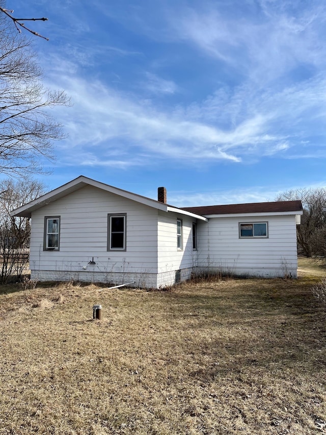 back of house with a lawn