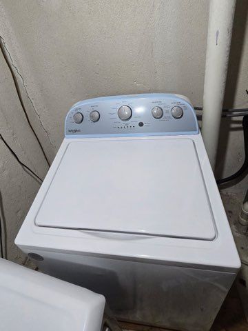 laundry room with washer / dryer, laundry area, and a textured wall