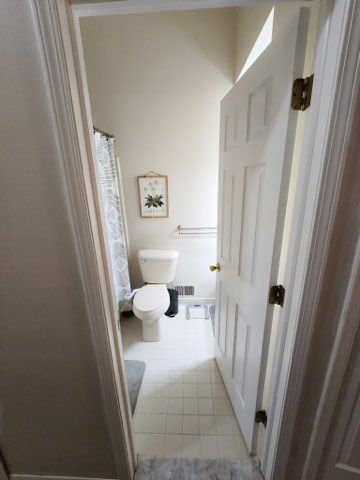 full bath with tile patterned flooring, visible vents, and toilet