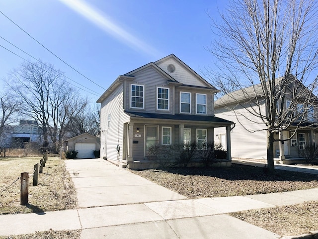 traditional-style home with an outbuilding, covered porch, concrete driveway, and a detached garage