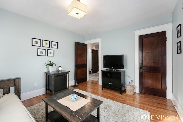 living area with wood finished floors and baseboards