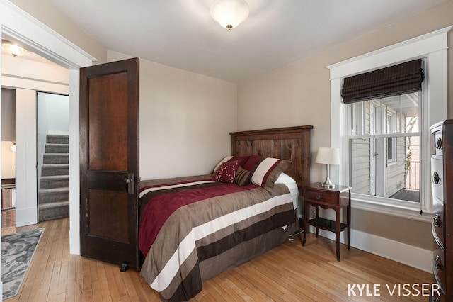 bedroom with baseboards and wood-type flooring