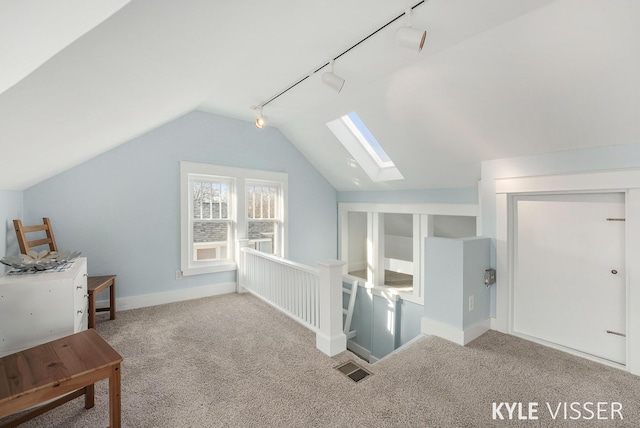 bonus room featuring visible vents, vaulted ceiling with skylight, and carpet