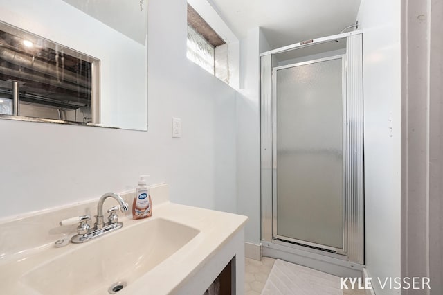 full bath featuring vanity and a shower stall