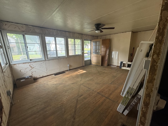 unfurnished sunroom with visible vents and ceiling fan