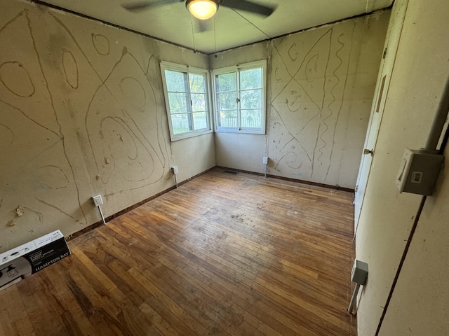 unfurnished bedroom featuring a ceiling fan and hardwood / wood-style floors