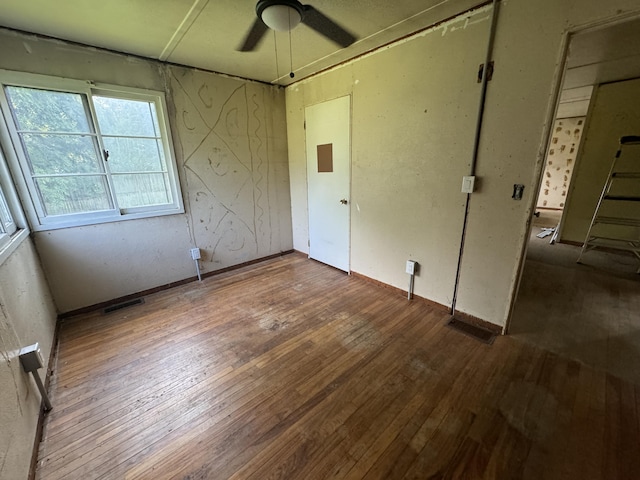 unfurnished bedroom with visible vents, a ceiling fan, and hardwood / wood-style flooring