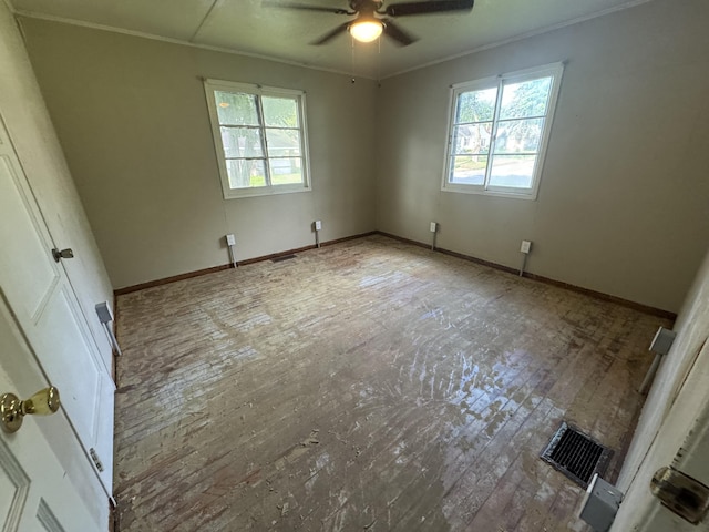 unfurnished bedroom with visible vents, a ceiling fan, crown molding, and baseboards