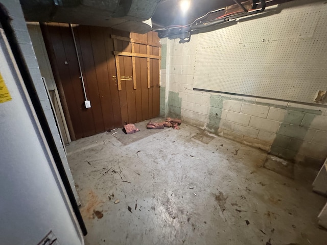 unfinished basement with concrete block wall