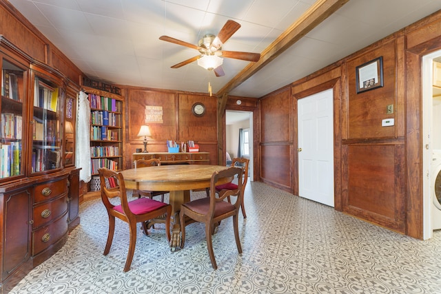 dining room with washer / dryer, wood walls, and ceiling fan