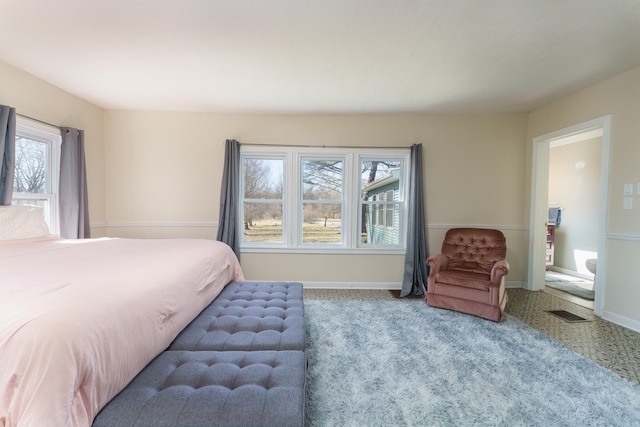 bedroom with visible vents, carpet, and baseboards