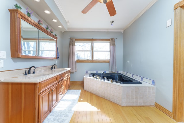 full bathroom featuring hardwood / wood-style floors, ornamental molding, and a sink