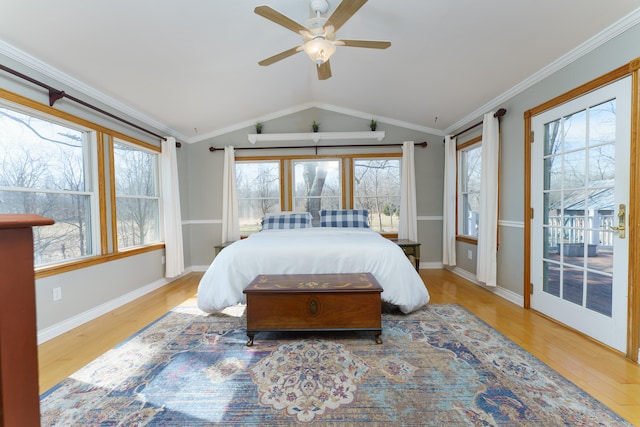 bedroom featuring vaulted ceiling, multiple windows, wood finished floors, and ornamental molding