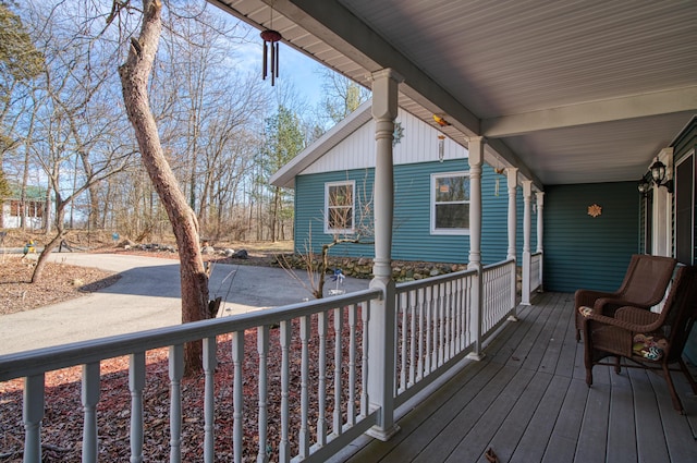 wooden terrace featuring covered porch