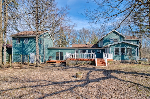 view of front of house featuring a deck and fence